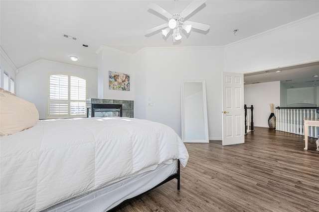 bedroom featuring visible vents, crown molding, wood finished floors, and vaulted ceiling