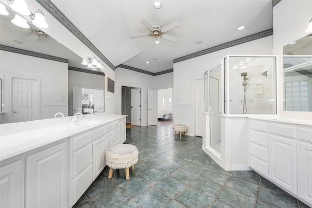 ensuite bathroom featuring vanity, a ceiling fan, recessed lighting, a shower stall, and ornamental molding