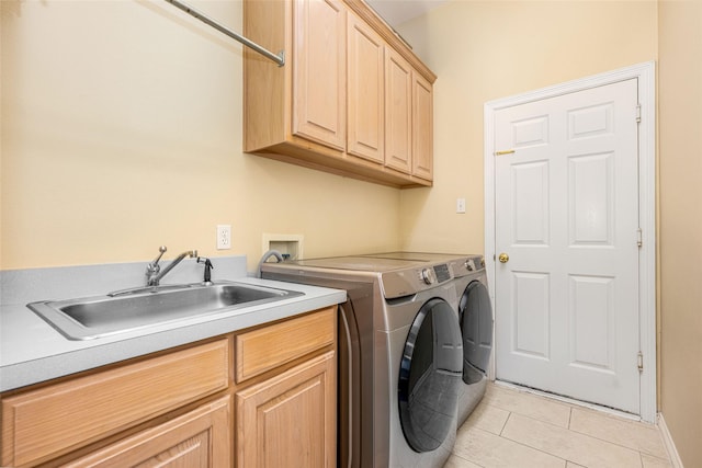 laundry room featuring a sink, separate washer and dryer, light tile patterned flooring, and cabinet space