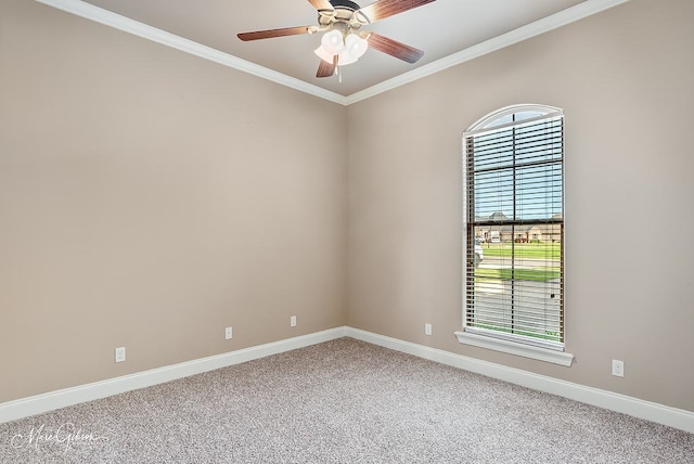 spare room with light carpet, baseboards, crown molding, and ceiling fan