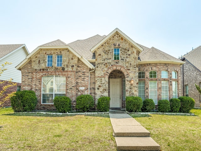 610 Crockett Dr, Lavon, TX 75166 - french country inspired facade featuring a shingled roof, brick siding, and a front lawn