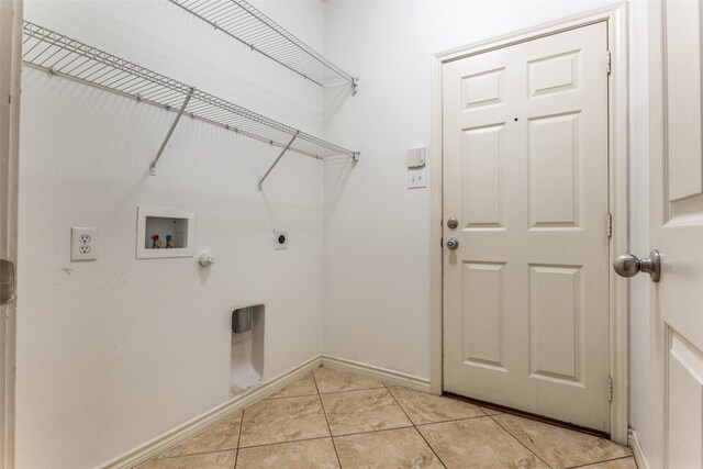 610 Crockett Dr, Lavon, TX 75166 - clothes washing area featuring laundry area, hookup for a washing machine, electric dryer hookup, light tile patterned flooring, and baseboards