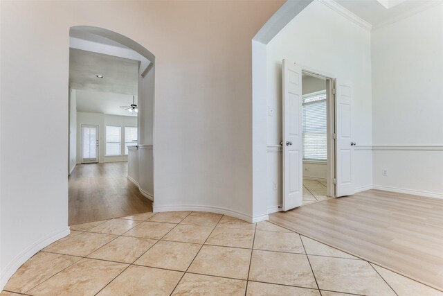 610 Crockett Dr, Lavon, TX 75166 - hall featuring crown molding, light tile patterned flooring, baseboards, and arched walkways