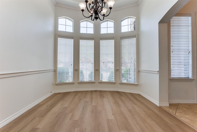 610 Crockett Dr, Lavon, TX 75166 - unfurnished dining area with a notable chandelier, light wood-style flooring, baseboards, and crown molding