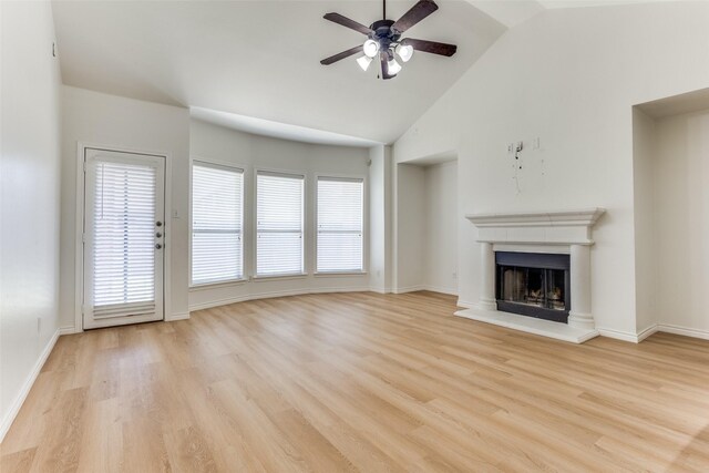 610 Crockett Dr, Lavon, TX 75166 - unfurnished living room with light wood-style floors, ceiling fan, a fireplace with raised hearth, and a wealth of natural light