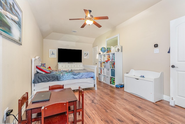 bedroom with visible vents, vaulted ceiling, a ceiling fan, and wood finished floors
