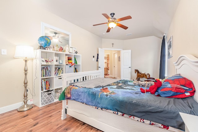 bedroom featuring baseboards, a ceiling fan, and wood finished floors
