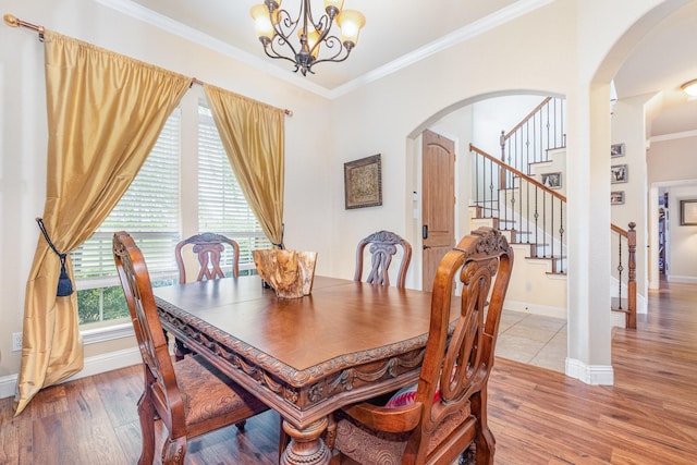 3608 Bright Star Way, Plano, TX 75074 - dining space featuring a chandelier, arched walkways, crown molding, light wood-style floors, and baseboards