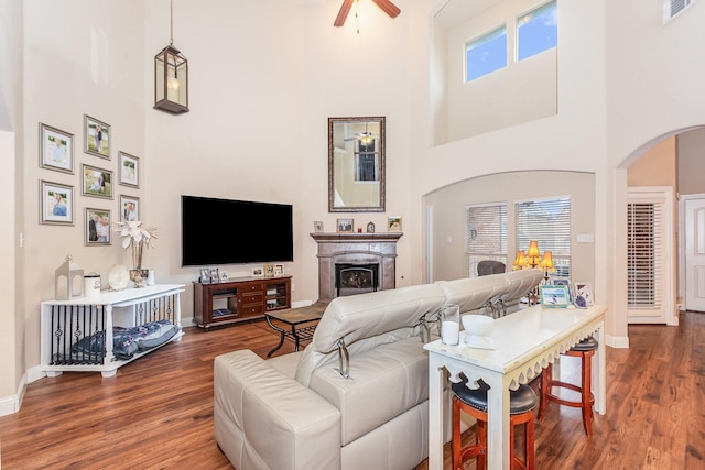 living room featuring visible vents, a high ceiling, and wood finished floors