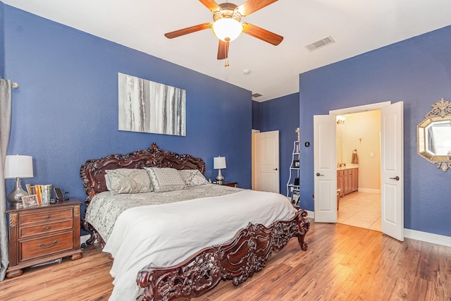 bedroom with visible vents, ceiling fan, baseboards, and wood finished floors