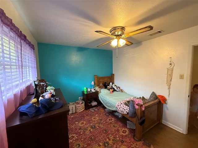 2909 Oakridge Dr, Corsicana, TX 75110 - bedroom featuring wood finished floors, a ceiling fan, and baseboards