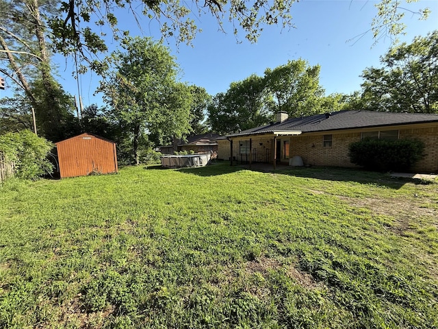 2909 Oakridge Dr, Corsicana, TX 75110 - view of green lawn with a storage shed and an outdoor structure