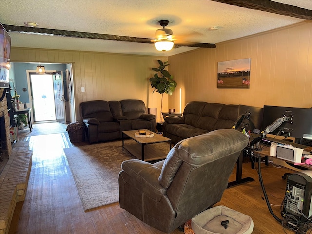2909 Oakridge Dr, Corsicana, TX 75110 - living area with a textured ceiling, wood finished floors, ceiling fan, and wooden walls