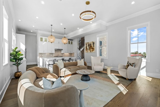 living room with ornamental molding, baseboards, and dark wood-style floors