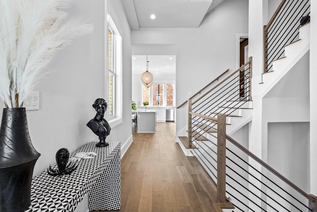 foyer entrance featuring recessed lighting, stairway, wood finished floors, and baseboards