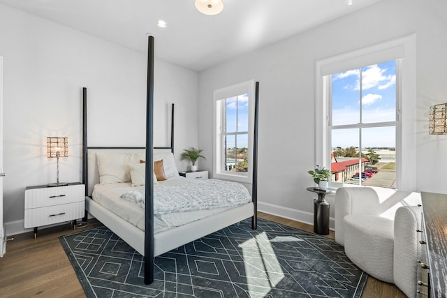 bedroom with baseboards and dark wood-style floors