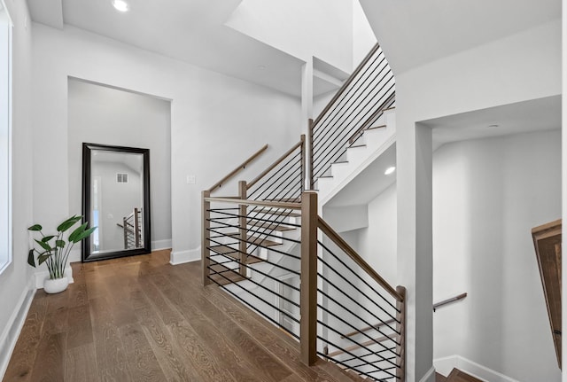 staircase with recessed lighting, visible vents, baseboards, and wood finished floors