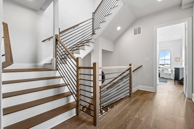 staircase with visible vents, baseboards, recessed lighting, and wood finished floors