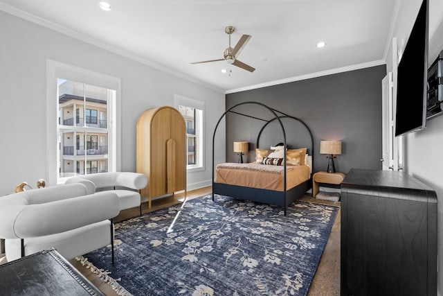 bedroom with crown molding, recessed lighting, and wood finished floors