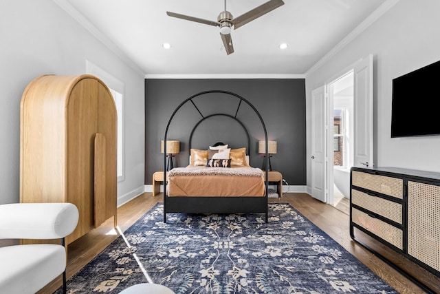 bedroom with crown molding, wood finished floors, and baseboards