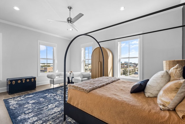 bedroom featuring crown molding, baseboards, recessed lighting, and wood finished floors
