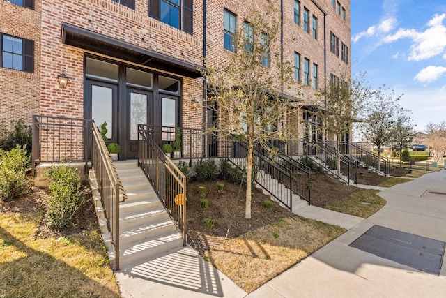 view of exterior entry with brick siding