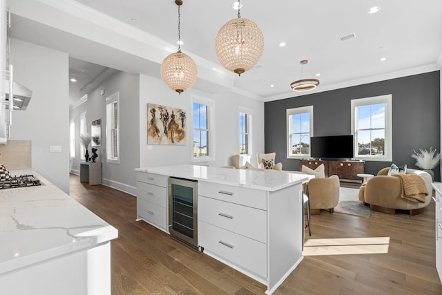 kitchen featuring crown molding, dark wood finished floors, beverage cooler, and modern cabinets