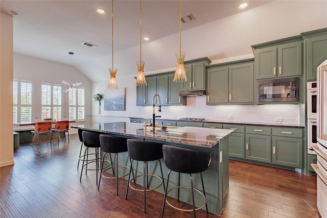 4300 Round Valley Ln, Fort Worth, TX 76262 - kitchen featuring built in microwave, a sink, green cabinetry, lofted ceiling, and stainless steel gas cooktop