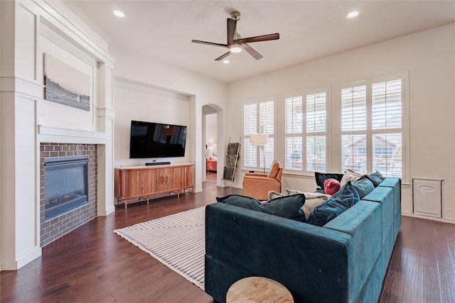 4300 Round Valley Ln, Fort Worth, TX 76262 - living room with ceiling fan, dark wood-style floors, a tiled fireplace, arched walkways, and recessed lighting