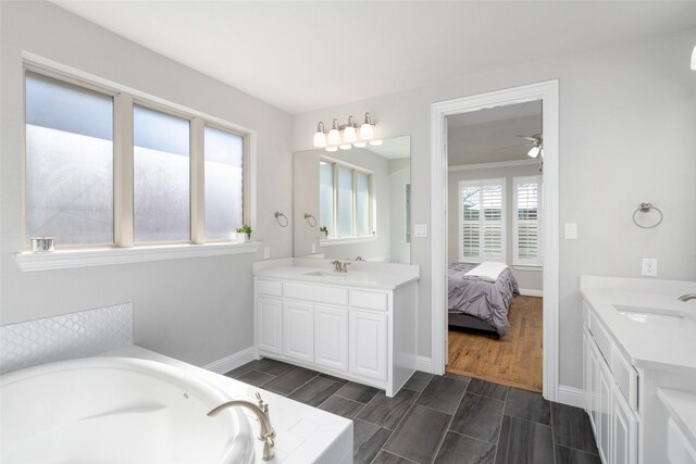 1128 Ellicott Dr, Celina, TX 75009 - full bathroom featuring vanity, a garden tub, a ceiling fan, and connected bathroom