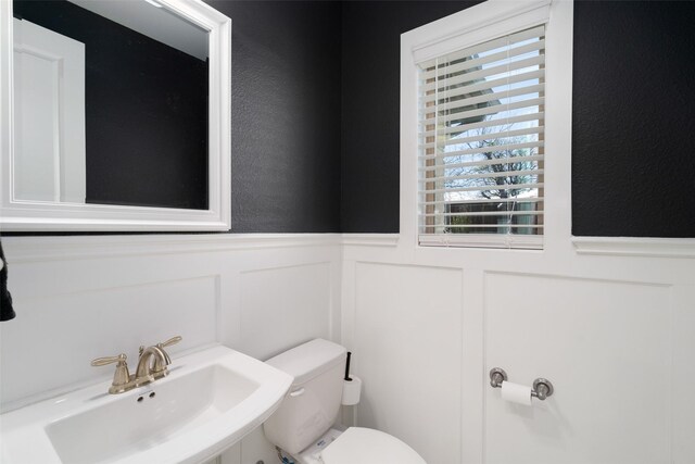1128 Ellicott Dr, Celina, TX 75009 - bathroom with a wainscoted wall, a sink, a decorative wall, and toilet