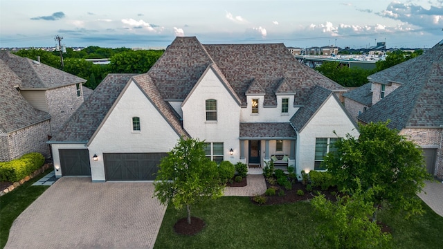 1128 Ellicott Dr, Celina, TX 75009 - french country style house with driveway, brick siding, and a shingled roof