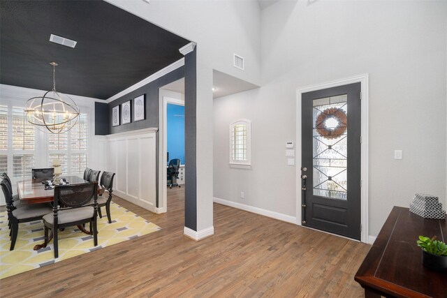 1128 Ellicott Dr, Celina, TX 75009 - foyer entrance with a chandelier, light wood-style flooring, and baseboards