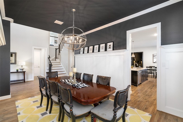 1128 Ellicott Dr, Celina, TX 75009 - dining space with a chandelier, stairway, and light wood finished floors