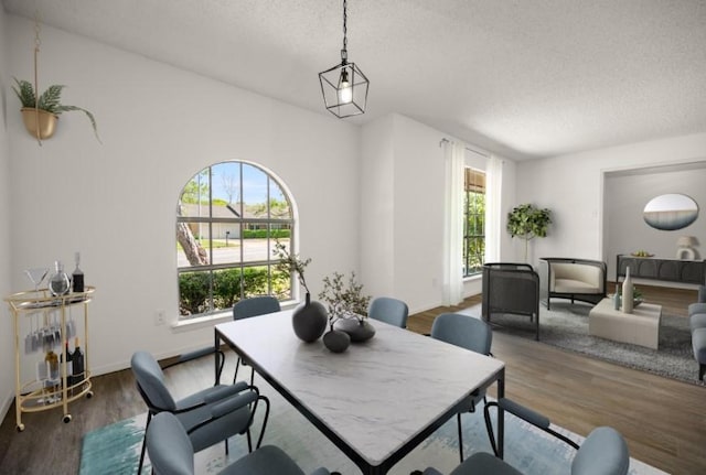 6516 Welch Ave, Fort Worth, TX 76133 - dining area featuring a textured ceiling, wood finished floors, and baseboards