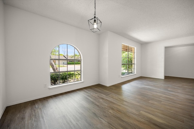 6516 Welch Ave, Fort Worth, TX 76133 - unfurnished room featuring plenty of natural light, wood finished floors, a textured ceiling, and baseboards