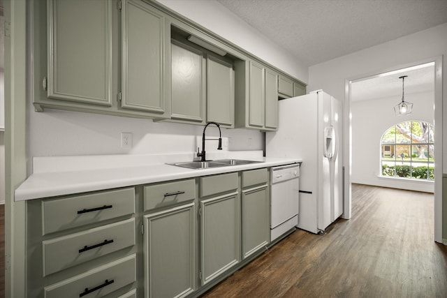 6516 Welch Ave, Fort Worth, TX 76133 - kitchen featuring a sink, white appliances, dark wood finished floors, green cabinets, and light countertops