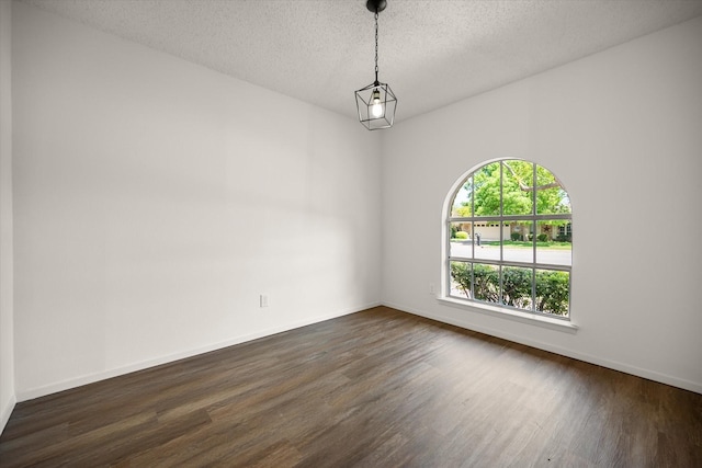 6516 Welch Ave, Fort Worth, TX 76133 - empty room with dark wood-style floors, a textured ceiling, and baseboards
