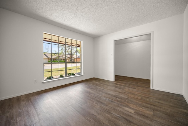6516 Welch Ave, Fort Worth, TX 76133 - unfurnished bedroom featuring dark wood finished floors, a textured ceiling, and baseboards
