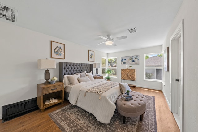 bedroom with wood finished floors and visible vents