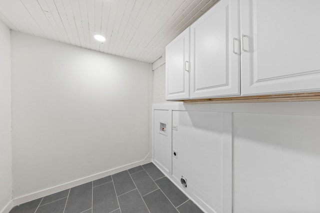 washroom featuring cabinet space, dark tile patterned floors, electric dryer hookup, and washer hookup