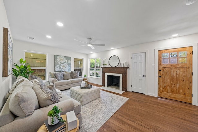 living room with recessed lighting, plenty of natural light, ceiling fan, and wood finished floors