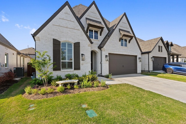 view of front of property featuring brick siding, an attached garage, a front lawn, and concrete driveway