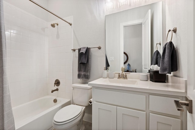 bathroom featuring bathtub / shower combination, vanity, and toilet