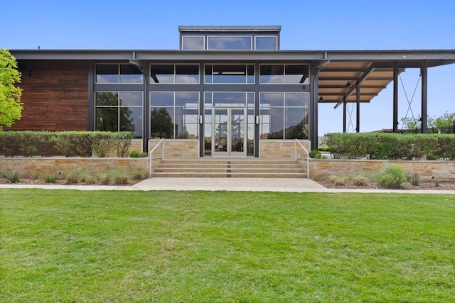 exterior space featuring entry steps, a sunroom, and a yard