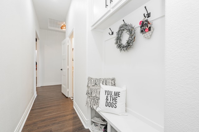 mudroom with dark wood-style floors and baseboards