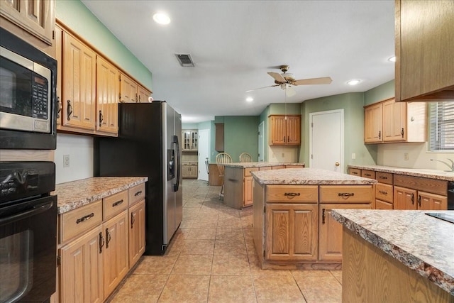 kitchen featuring visible vents, light countertops, a ceiling fan, and appliances with stainless steel finishes