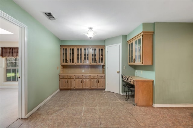 bar with decorative backsplash, baseboards, and visible vents