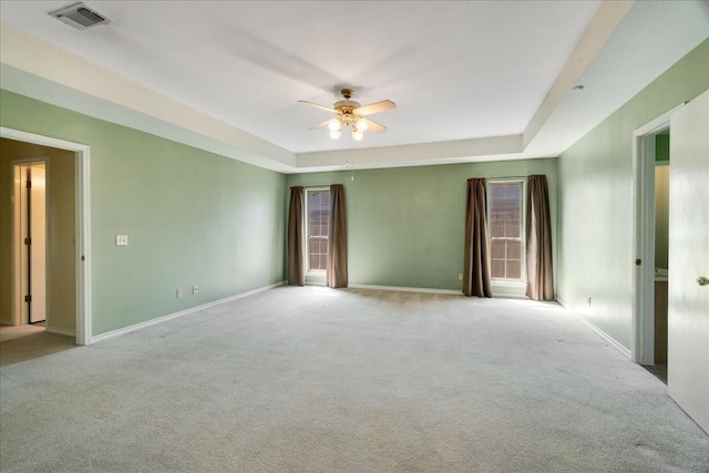 spare room featuring visible vents, ceiling fan, carpet, and baseboards