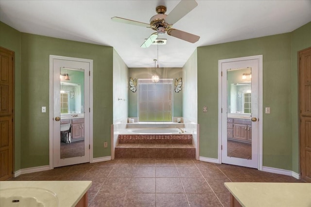 full bath featuring vanity, a bath, baseboards, and ceiling fan